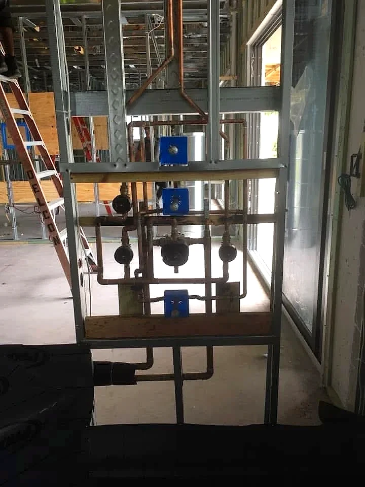 Copper shower rough-in in a new construction home with metal framing, Florida