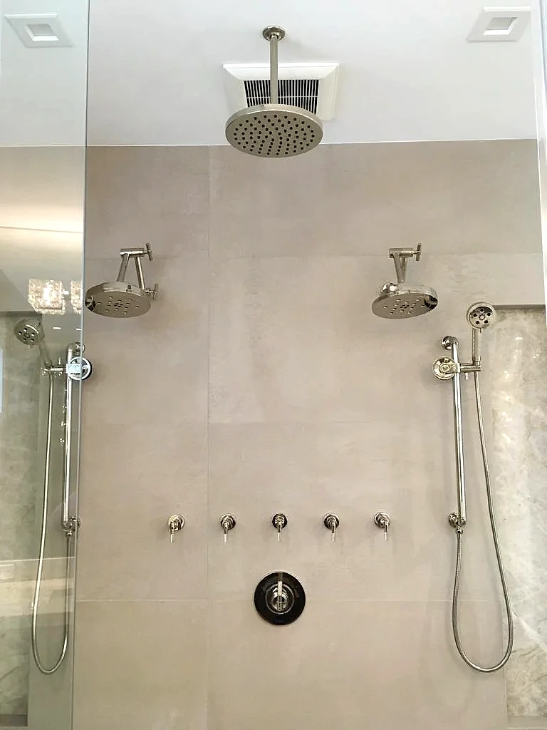 Finished dual shower system with rain heads, handhelds and body sprays, South Florida