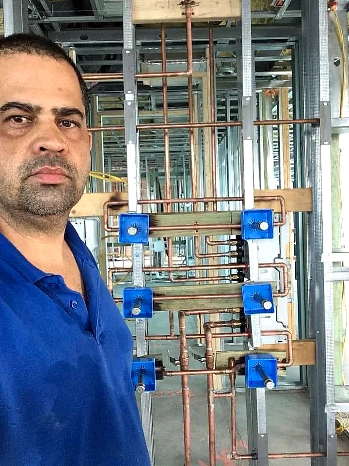 Roger Costa, owner of Right Choice Plumbing, next to a copper manifold he installed