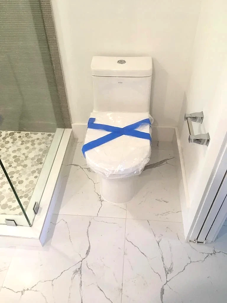 Toilet reset with a new wax ring in a renovated bathroom