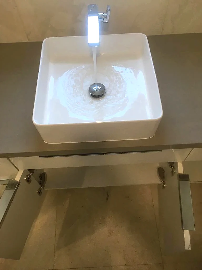 Vessel sink and tall faucet installed on a floating vanity, Florida